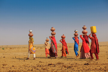 Water carrier of Cholistan.
The female was carrying a water pitcher on her head, bringing water to their houses in the Cholistan desert from the government-built water supply tanks.