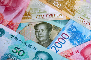 Chinese yuan banknotes and russian rubles. Concept of economic cooperation between the China and...