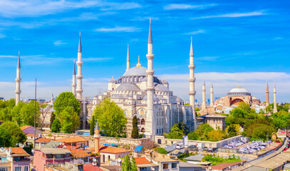 Aerial drone view of Sultanahmet or Blue mosque and Hagia Sophia in Sultanahmet district in Istanbul, Turkey against blue sky.