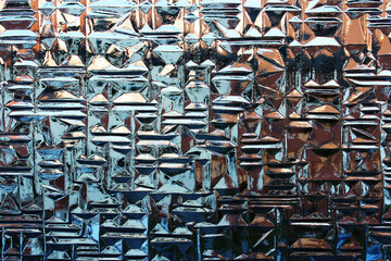 Close-up of a patterned window with reflections