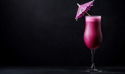 Frosted purple beverage in elegant glass, garnished with a small paper umbrella