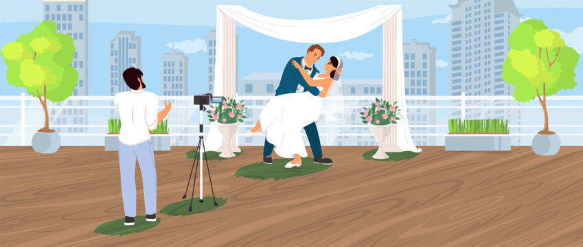 A couple joyfully celebrates their wedding on a rooftop, surrounded by greenery and floral arrangements, while a photographer captures their special moment against a city skyline.