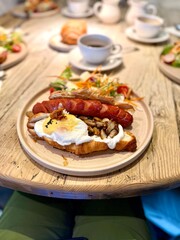 Croissant sandwich with sausage and poached egg served at breakfast