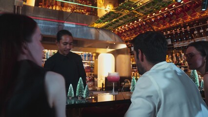 Asian bartender using strainer all ingredients alcohol liquor and syrup tasty in cocktail glass at...