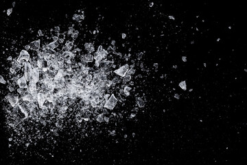 Ice, crushed on a black background. Shards of crushed ice spreading away. A heap of crushed ice.