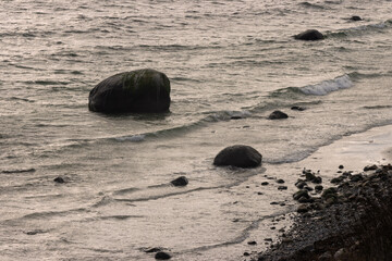 Ostseeküste mit Steinen im Wasser.