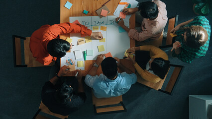 Top view of people writing and making scrum task board while writing marketing and planning...