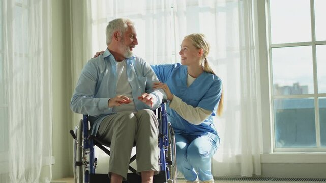 Help support retirement healthcare. Nurse helping old man in wheelchair. Patient and woman in nursing home for medical caregiver. Nurse taking care of paralyzed man in chair for people with disability