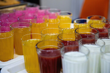 Multicolored tasty liquid in glasses. Catering.