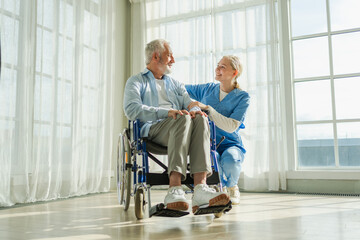 Help support retirement healthcare. Nurse helping old man in wheelchair. Patient and woman in...