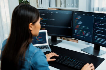 Young Asian in IT developer creating with typing online information on pc with coding program data...