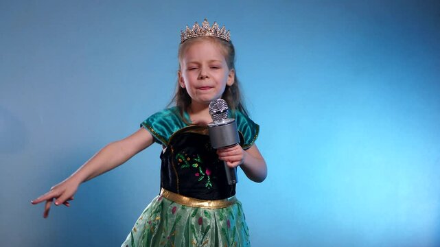 A little princess, voice soaring, a captivating performance. The Queen sings into the microphone and dances. Karaoke. Emerald gown, sparkling crown, a tiny starlet takes the stage. Hands clasped 