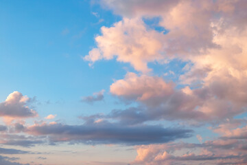 Blue sky with clouds and sunset lighting. Natural cloud landscape background