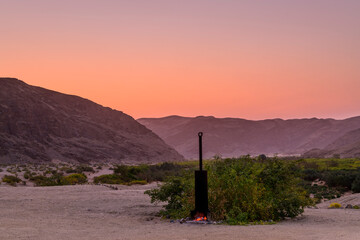 Boiler with burning Fire in Camp in a lonely River Valley at Sunset, Damaraland, Namibia