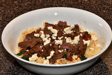 Delicious Beef and Couscous Dish with Feta and Fresh Vegetables