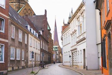 Fototapeta premium Cobblestone street in Bremen, Germany, with classic European architecture on both sides