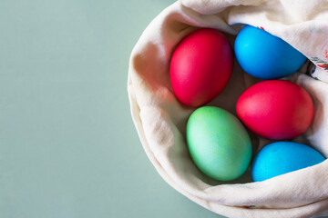 Bright Easter eggs in a kerchief nest. Top view.