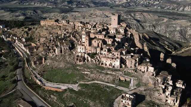 4K panoramic view of Craco, a ghost town in the Basilicata region of Italy. Stunning aerial footage capturing the historic ruins and breathtaking landscape.