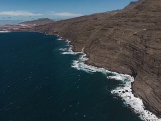 Aerial View of Rocky Coastline and Ocean Waves