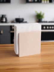 wooden napkin holder with white napkins on the background of a light kitchen