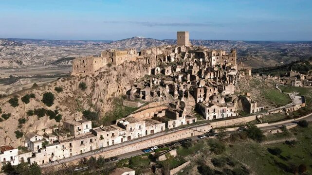 Stunning panoramic shot of Craco, an ancient abandoned city in the Basilicata region of Italy. 4K aerial footage highlighting this unique tourist attraction.