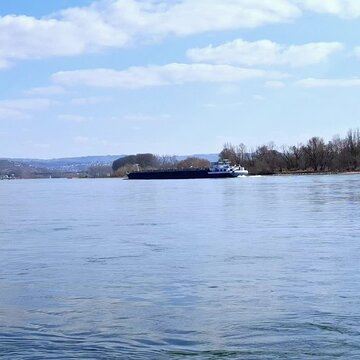 River on sunny day snd  blue sky with moving ship 