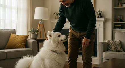 a man in a house petting a dog