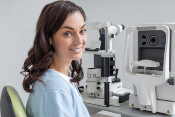 Woman patient testing vision in optometry clinic measuring eyesight