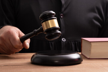 close-up of the judge's hand with the gavel, justice and law