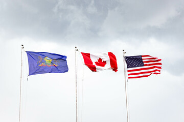 USA, Pennsylvania and Canada Flag flying in heavy winds