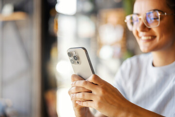 Close up of girl's hands typing messages on cellphone.