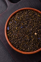 Dry green tea with soursop piece, knapweed petals in bowl