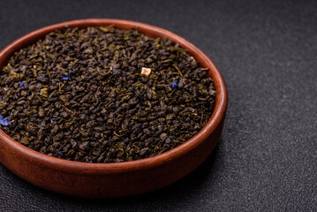 Dry green tea with soursop piece, knapweed petals in bowl