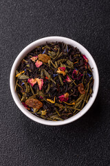 Dry tea mix blend black, green and flower petals in bowl