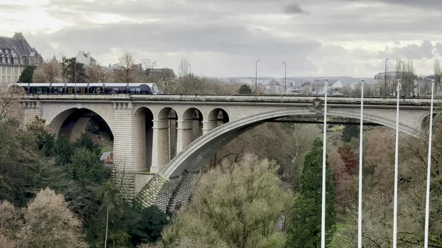 Luxembourg's Adolphe Bridge - Historic Stone Viaduct with Passing Tram