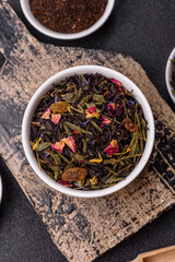 Dry tea mix blend black, green and flower petals in bowl