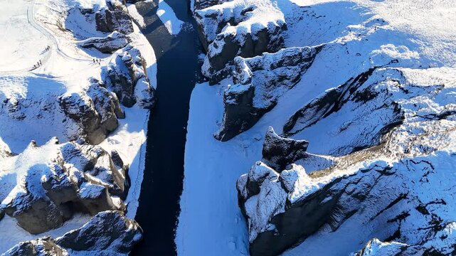 Fja&eth;r&aacute;rglj&uacute;fur ("feather river canyon") with the Fja&eth;r&aacute; river flowing through it. Kirkjub&aelig;jarklaustur, Iceland.
Scenic snow covered flight view of Fjadrargljufur canyon, south of Iceland during winter