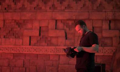 Director at work on the set. The director works with a group or with a playback while filming a...