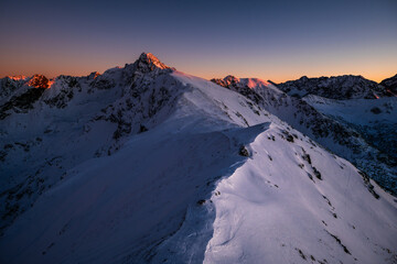 Snow-covered Mountain Peak at Sunset