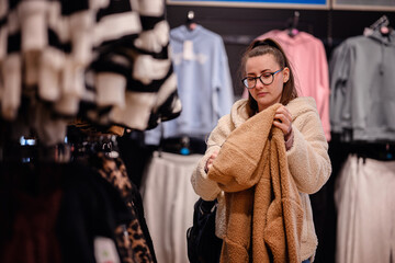Woman Shopping for a Cozy Jacket in Clothing Store