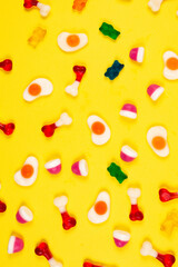 Assorted jelly sweets on yellow background. Pattern.