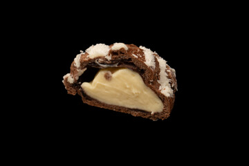 Profiteroles with coconut cream on a black background.