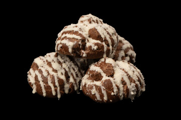 Profiteroles with coconut cream on a black background.