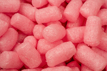 Pink and white box filler as a background. Top view.