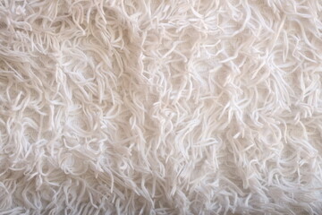 A close-up shot of a soft and fluffy white blanket.