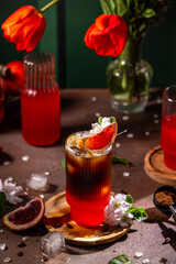 Refreshing red orange and coffee fusion with ice and flowers