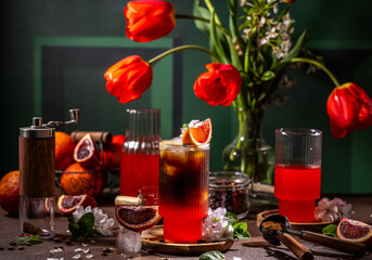 Refreshing iced coffee mixed with blood orange juice and decorated with flowers