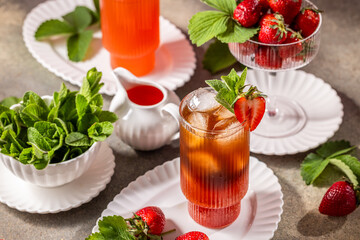 Refreshing strawberry iced tea with fresh mint and ice cubes