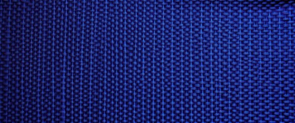 Intricate woven textile with subtle sheen, deep indigo hues, art, vintage