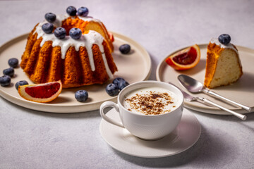 Delicious gugelhupf cake with blueberries, blood orange and cappuccino for perfect breakfast